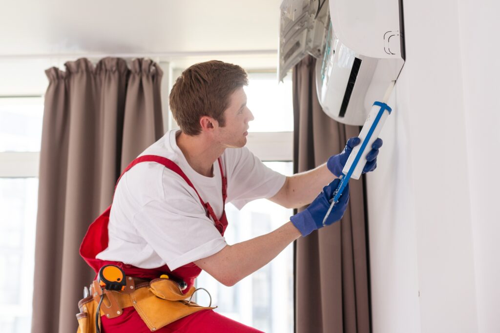 Service man is cleaning, repair and maintenance of air conditioner